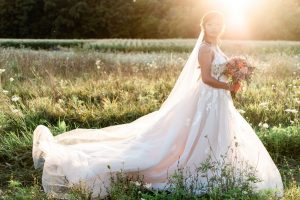 bride in grassy field